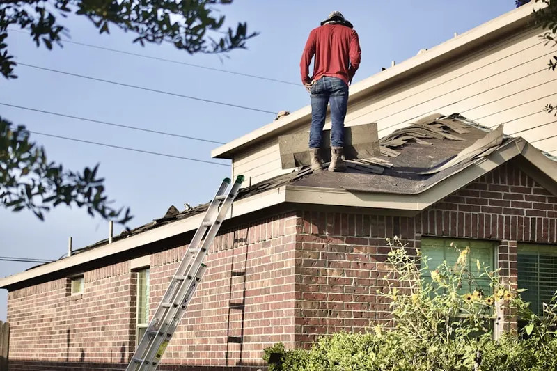 Professional roofer working on a residential roof in Rosegate Manor